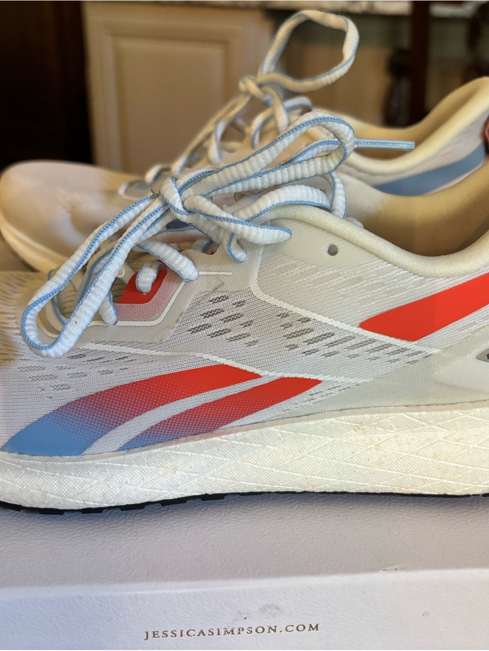 Reebok Forever 2.0 White Running Sneakers with Coral & Sky Blue Accents.